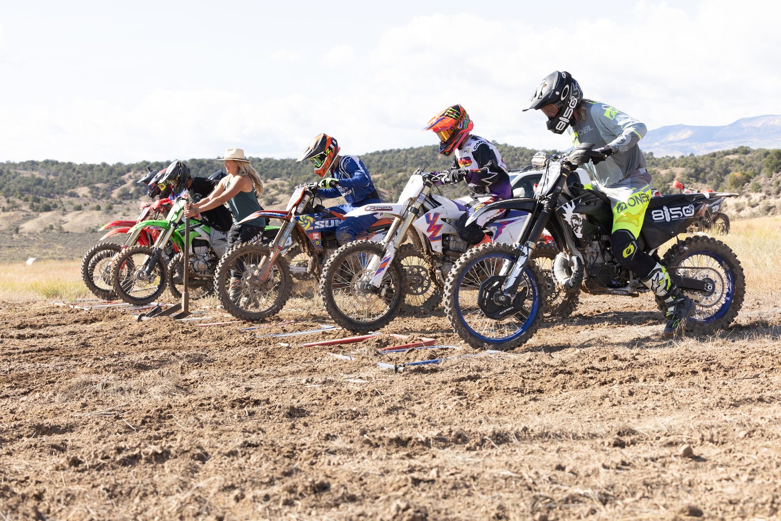 A row of motocross riders launching off the starting gate together at Dry Lake Motocross Park