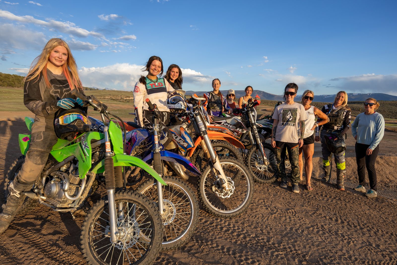 Women and girls posing with their dirt bikes at Dry Lake during a Girls Ride Toosday session